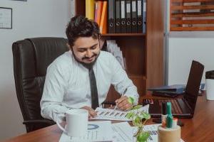 Business man looking at papers on his desk.